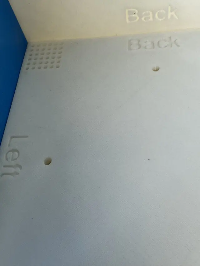 Embossed panel labels and screw holes, macro